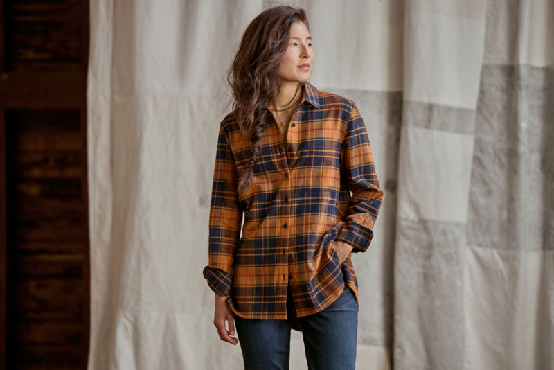 Model wearing orange flannel and jeans