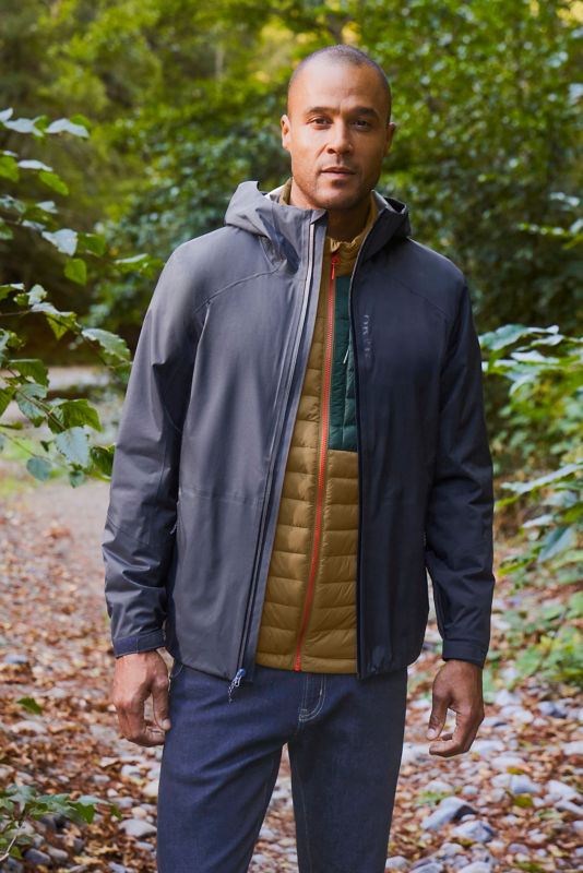 Man wearing navy jacket, navy 1/4 zip and JQD pants