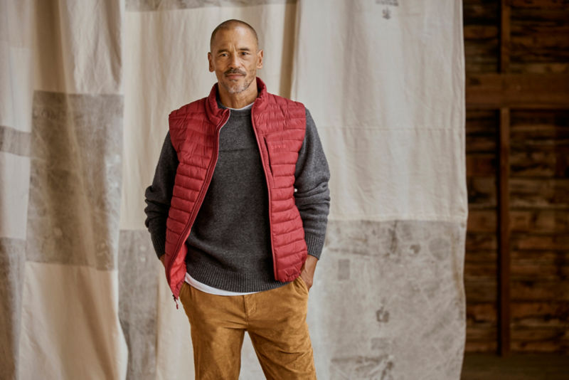 Man wearing red Drift vest and dark grey sweater.