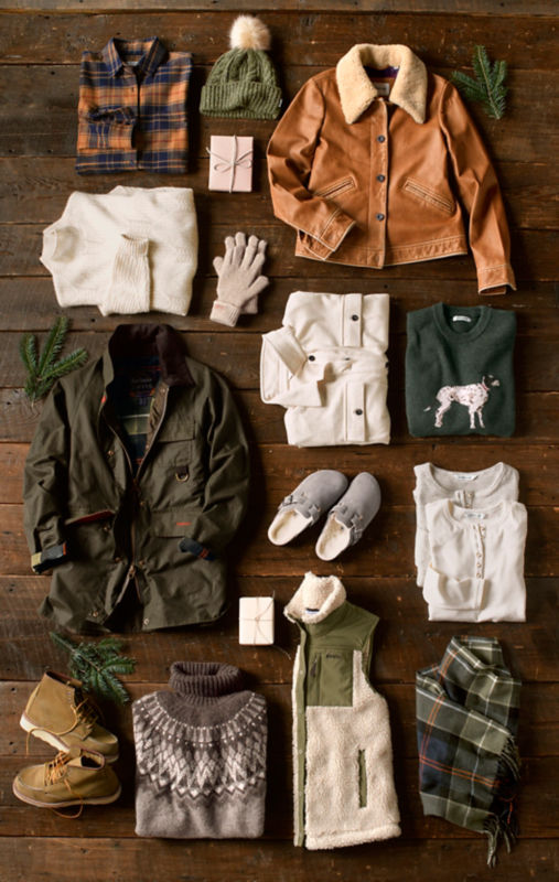 A collection of Orvis gifts laid out on a wooden table.