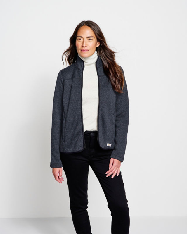 Model wearing jacket with cream turtleneck