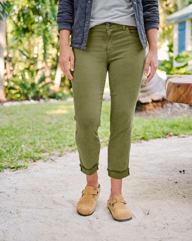 Woman wearing green jeans outside lower body only