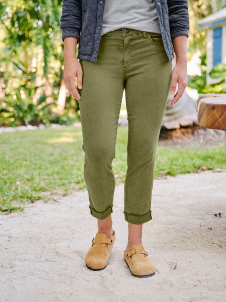 Woman wearing green jeans outside lower body only