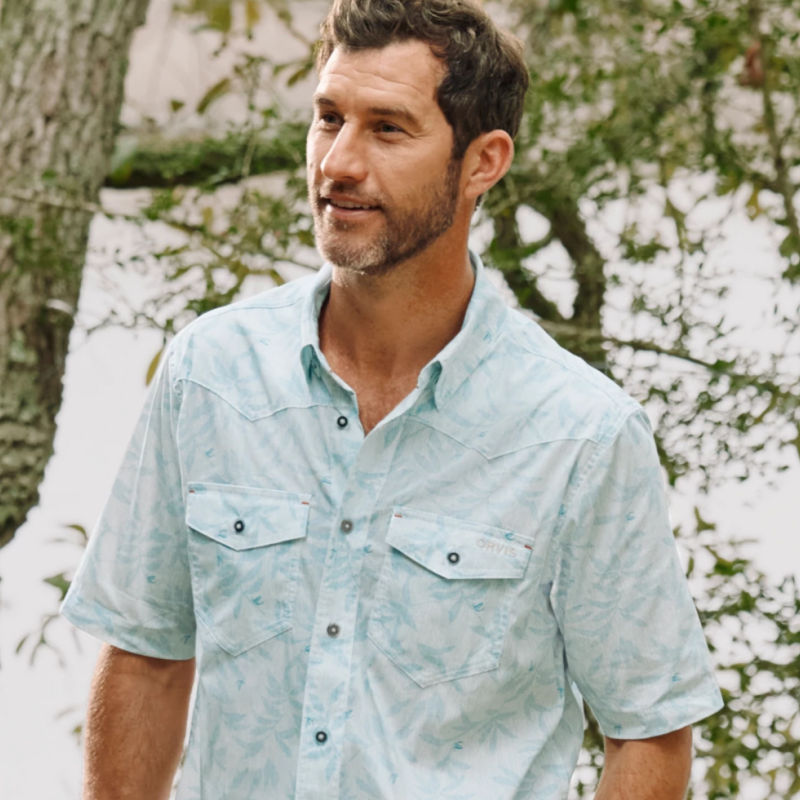 A model in an ice blue short-sleeve button-down.