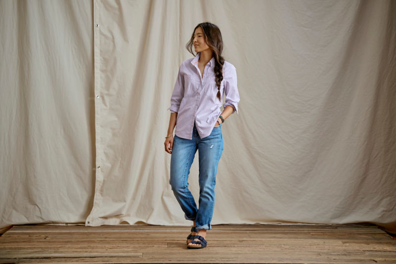 Woman wearing River Guide shirt and jeans in a studio.