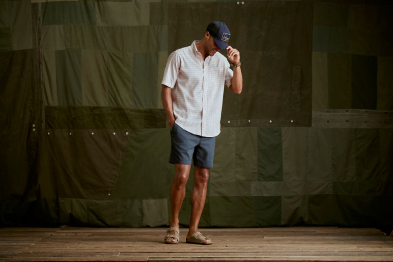 A model wearing a brown and cream patterned short-sleeve button-down.