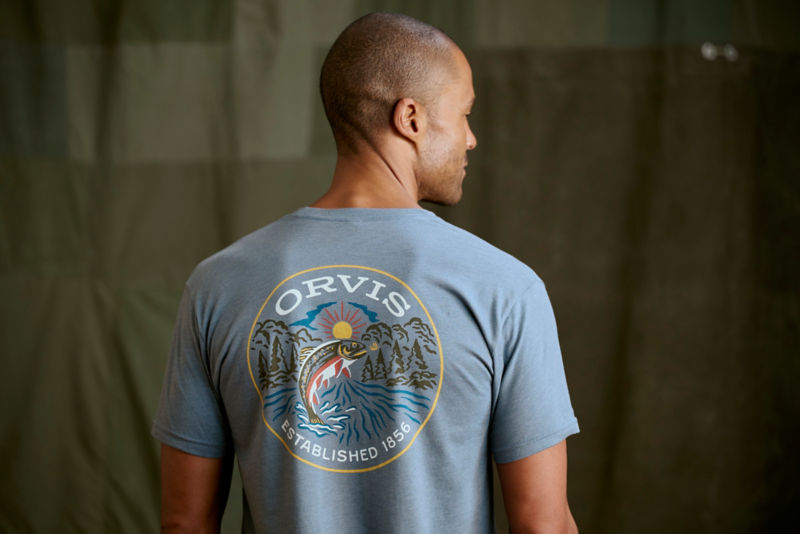 A man in a blue and white Orvis Logo T-shirt.