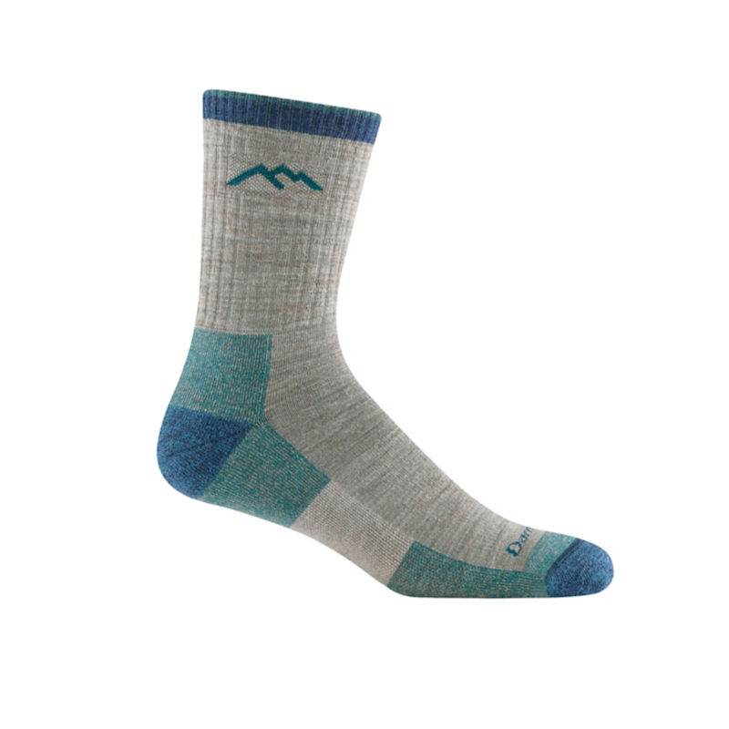 A gray and teal Darn Tough sock with mountains on the side.