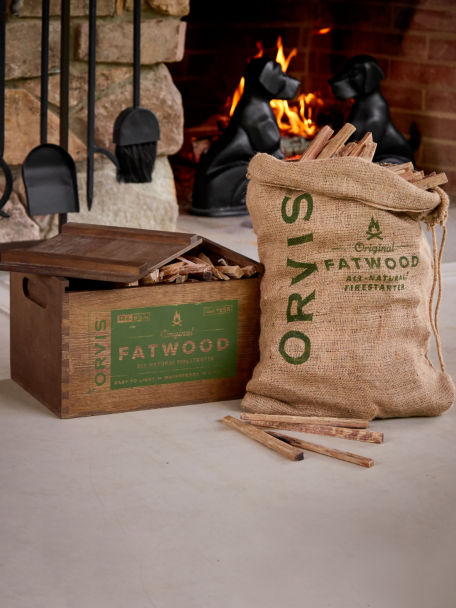 Fatwood box and bundle against a roaring fireplace.