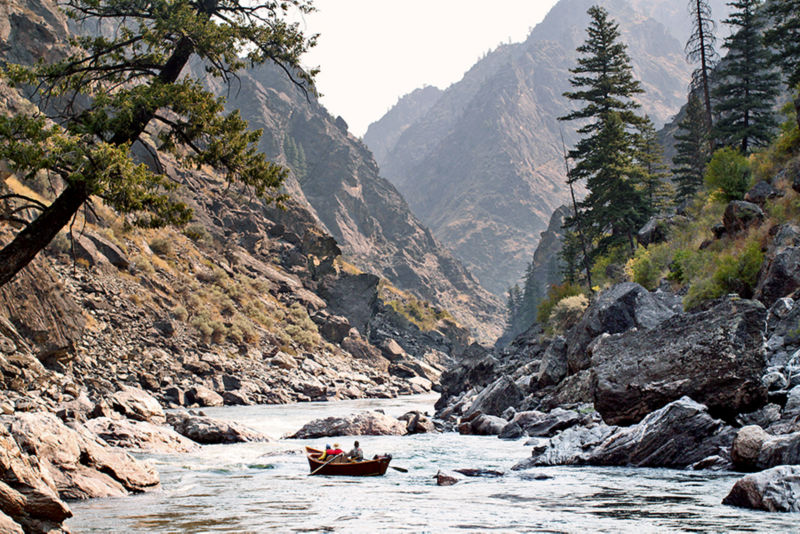 Anglers direct their boat into a rocky canyon.