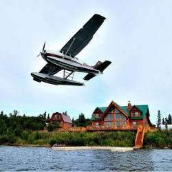 A float plane taking off with Bristol Bay Lodge in the background