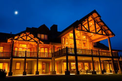A front side view of the lodge lit up at night.