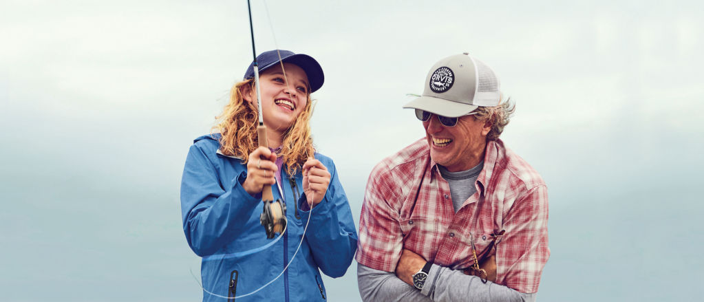 father teaching his daughter how to cast a fly rod