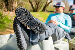 An angler takes a break and puts his feet up, showing the Michelin-designed outsole of the PRO wader boot.