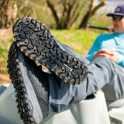 An angler takes a break and puts his feet up, showing the Michelin-designed outsole of the PRO wader boot.