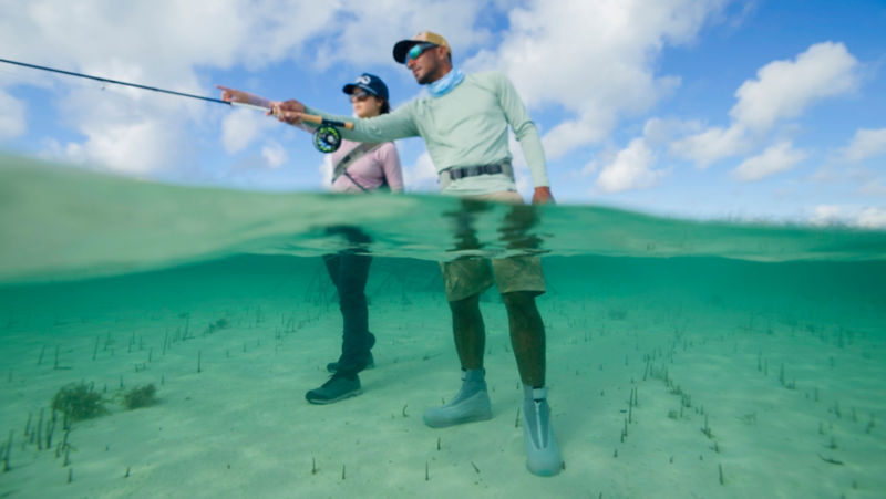 An angler gets direction from a guide in the Bahamas.