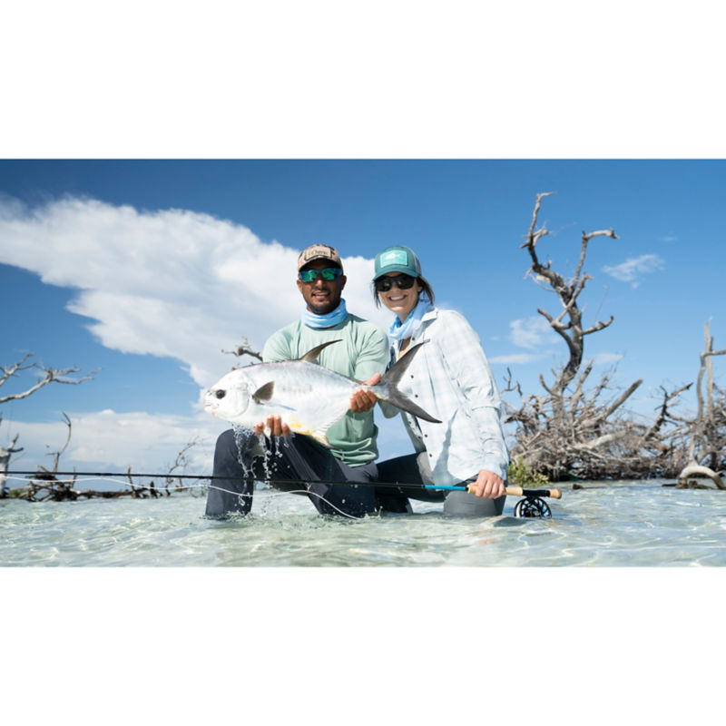 Two anglers bump show off a beautiful permit.