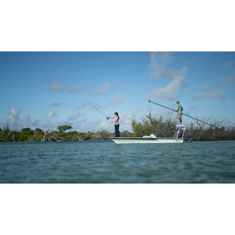 An angler casts from the front of a skiff in the Bahamas.