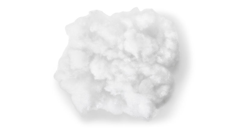 A close up shot of fluffy, soft fill that's inside a dog bed.