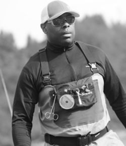 Black and white photo of Chad Brown wearing fishing gear