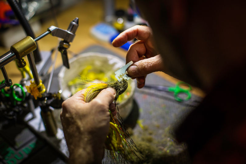Using a razor blade to fine-tune a freshly tied fly.