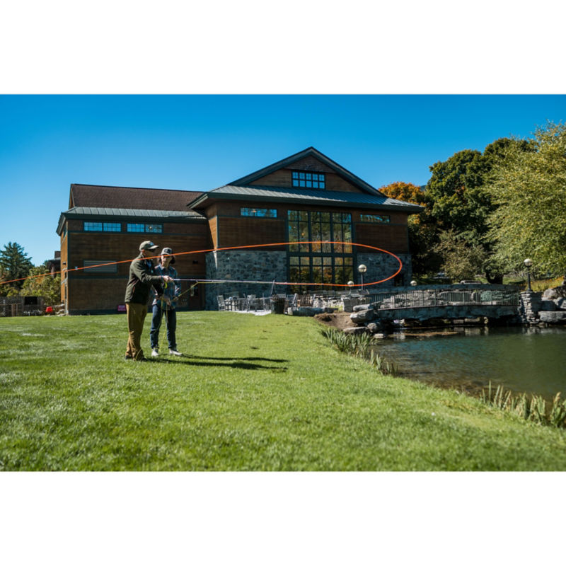 A student being taught how to cast into a pond at the Manchester Orvis store