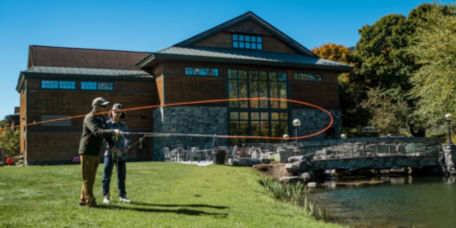 A student being taught how to cast into a pond at the Manchester Orvis store