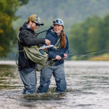 Anglers adjust their gear in the Delaware River.