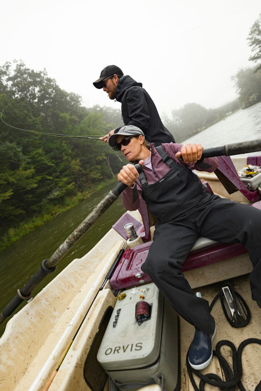 Angler loads a PRO Waterproof Boat Bag 28L into his boat.
