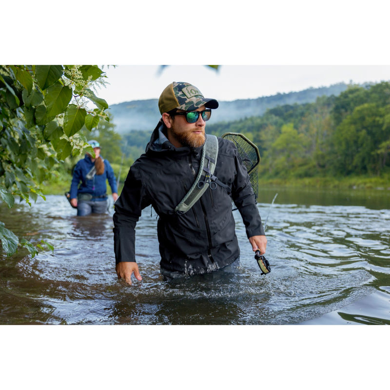 A man wades waist deep down the Delaware River.