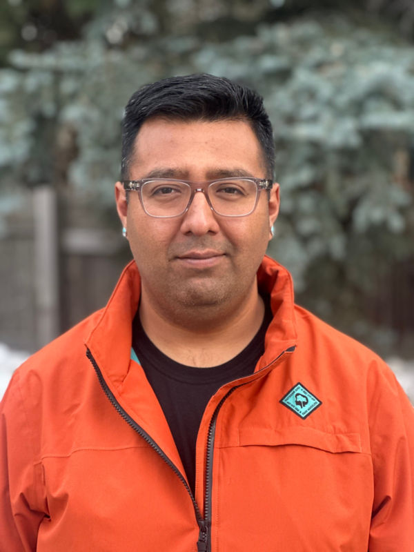 A close up shot of Dominic Lucero wearing an orange jacket.