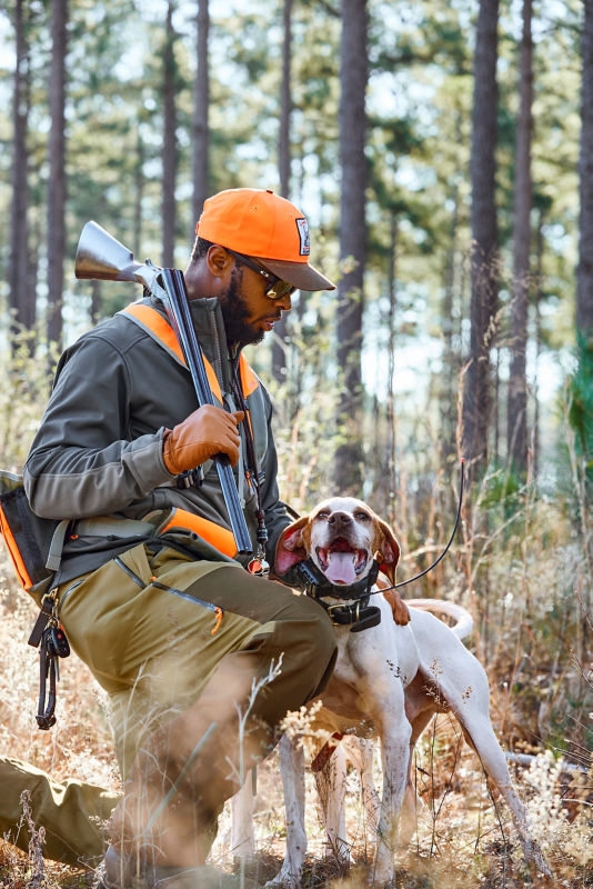 Orvis-Endorsed Wingshooting Guide Durrell Smith in his Upland Softshell Jacket with his dog