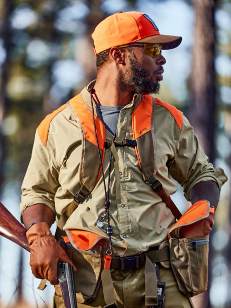 Durrell Smith checks for shells in his PRO LT Hunting Vest as he looks about the woods around him.