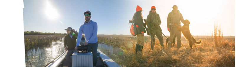 A man in a boat fishing on the left and 4 hunters standing in a field on the right