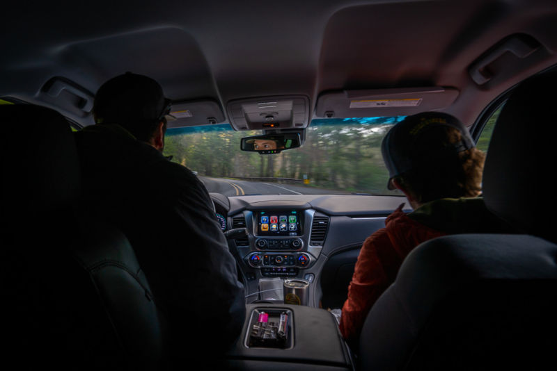 Two people inside a pickup truck.