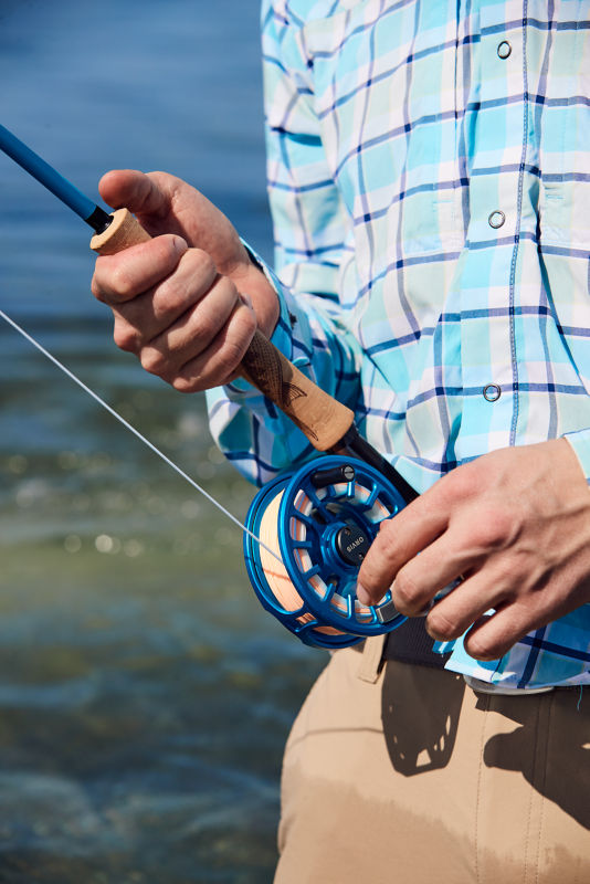 A man fishes with a Hydros Reel Outfit.
