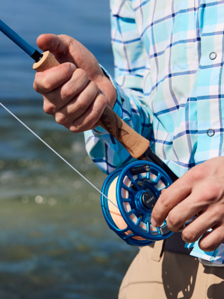 A man fishes with a Hydros Reel Outfit.