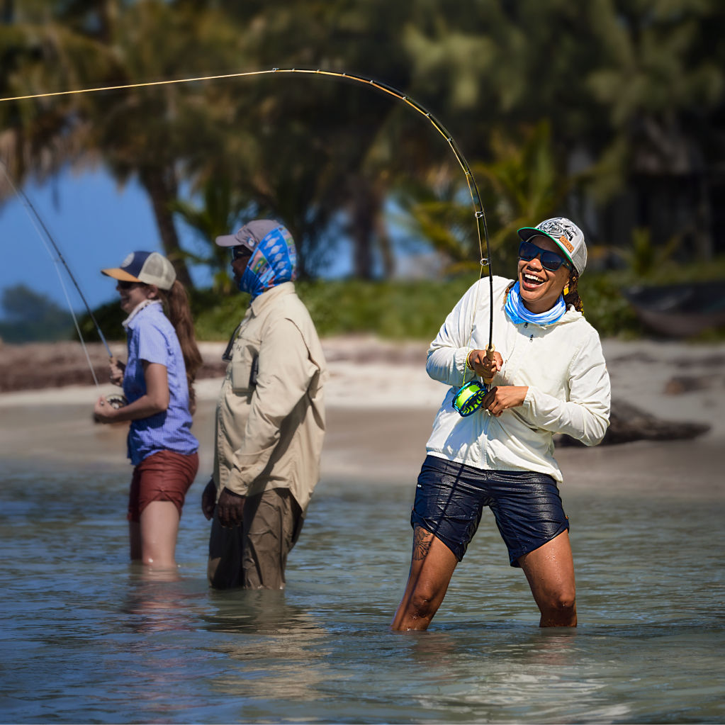 Fish on the line for angler beachside in a tropical location.