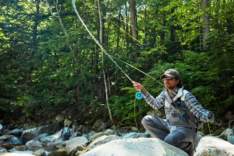 Angler crouched shooting line off of a Helios 3F.