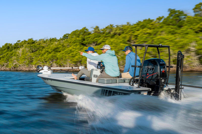Three people in a motor boat speeding through Florida Bay