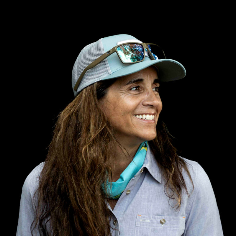 A headshot of Dr. Jennifer Rehage with sunglasses resting on her baby blue ball cap