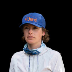 A headshot of Hannah Perkins in a blue Orvis ball cap