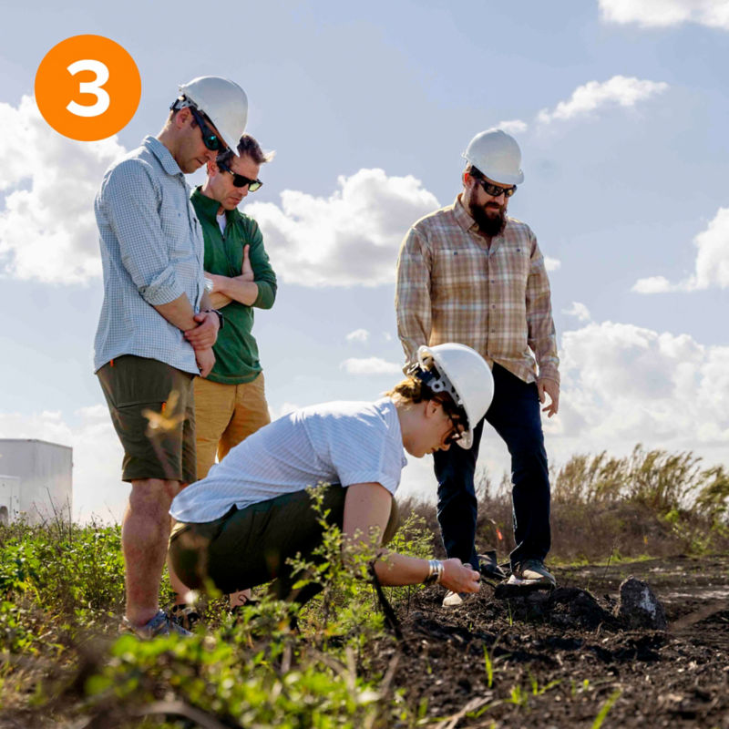Four people soil-testing on the bank of Lake Okeechobee