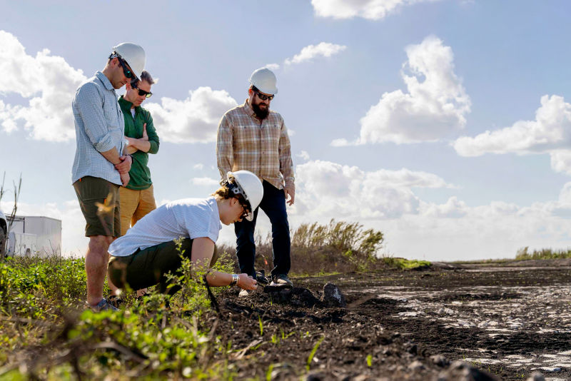 Four people test soil in the Everglades watershed