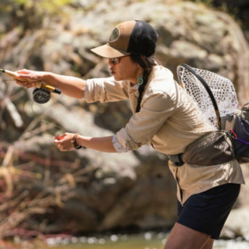 Woman in Tech Chambray Shirt goes fishing in the woods.