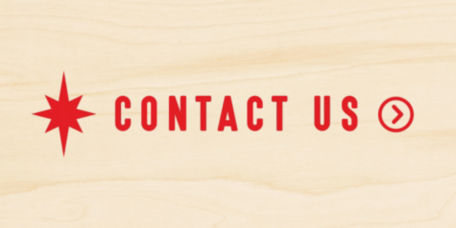 Contact Us in red letters on a wooden background.