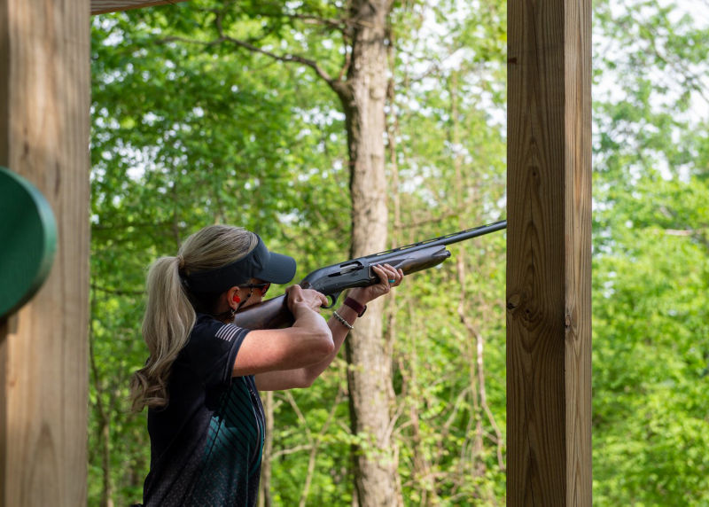 A woman practicing shooting clays