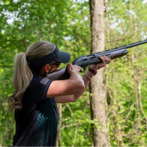 A woman practicing shooting clays