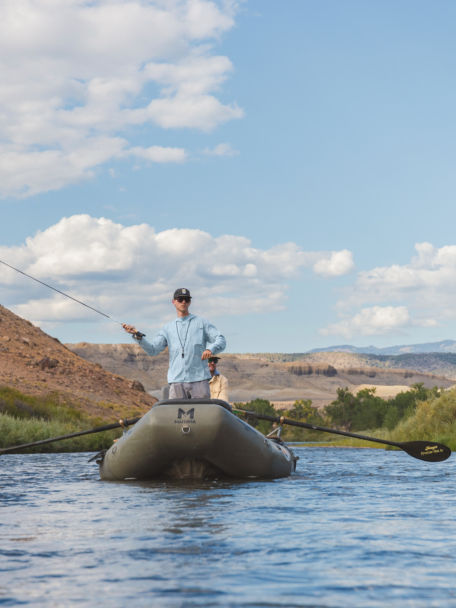 Man fly fishes with a Helios fly rod