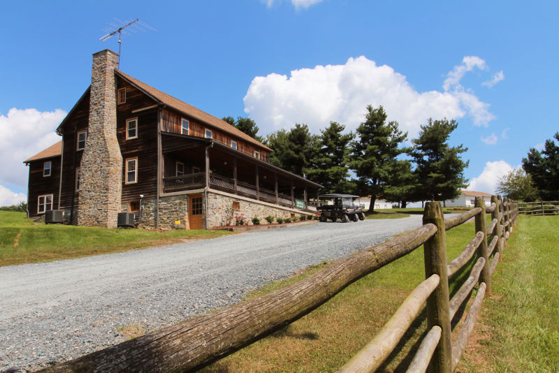 A large wooden lodge at Hill Country Shooting grounds.